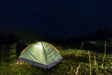 Tent at night in the field. Starry night.