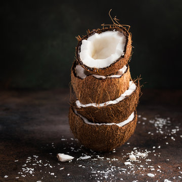 stack of coconut half and coconut flakes