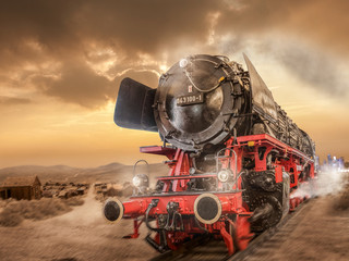 Steam locomotive drives through the desert