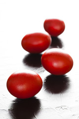 Red easter eggs on plastered background