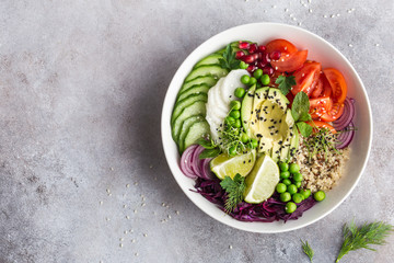 healhty vegan lunch bowl. Avocado, quinoa, tomato, cucumber, red cabbage, green peas and radish  vegetables salad.