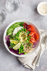 healhty vegan lunch bowl. Avocado, quinoa, tomato, cucumber, red cabbage, green peas and radish  vegetables salad.