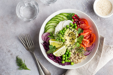 healhty vegan lunch bowl. Avocado, quinoa, tomato, cucumber, red cabbage, green peas and radish  vegetables salad.