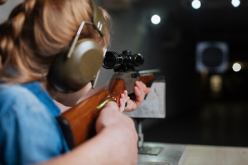 Nice pleasant girl developing her shooting skills