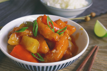 sweet and sour pork. deep fried crispy pork stir-fried with pineapple and fresh capsicum in sour and sweet sauce. worldwide famous chinese cuisine.