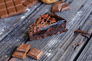 Brown milk chocolate on a wooden table.