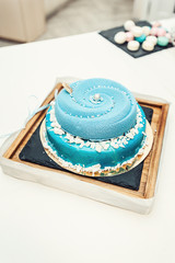 wedding blue cake with mini balls on a desk