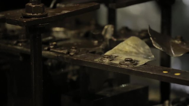 Bending Metal, piece of metal is bended by a machine. Metal tableware manufacturing, handle from mug