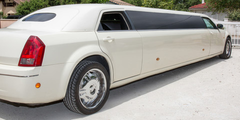 Rear view of a long white limousine car