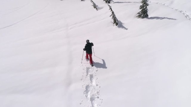 Drone Following Man Breaking Snowshoe Trail in Fresh Deep Powder Snow