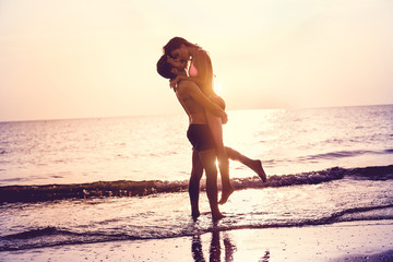 Couple in love having romantic tender moments at sunset on the beach