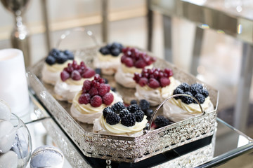 Candy bar. Cupcakes with fresh berries. Macaroons