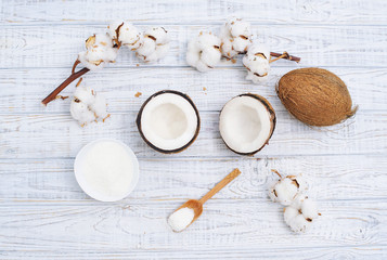 Fototapeta na wymiar Still life with coconut, coconut flakes and white cotton flowers, healthy organic food concept
