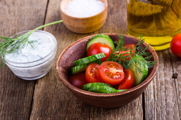 Salad of fresh tomato, cucumber and olive oil