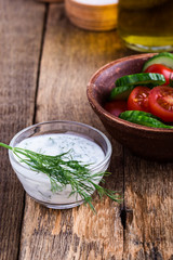Yogurt sauce with dill and tomato cucumber salad