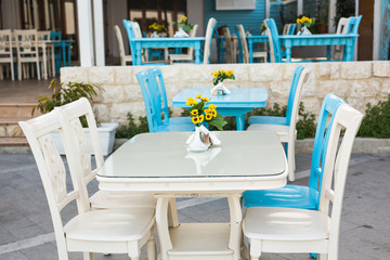 Fototapeta na wymiar old-fashioned Cafe terrace with tables and chairs