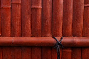 Orange Bamboo wall with black rope