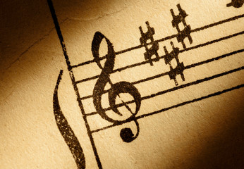 treble clef on old music sheet