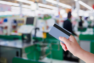 paying using credit card at supermarket checkout cashier