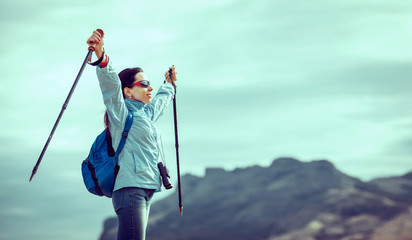 Naklejka premium Young traveler with backpack standing on the big stones