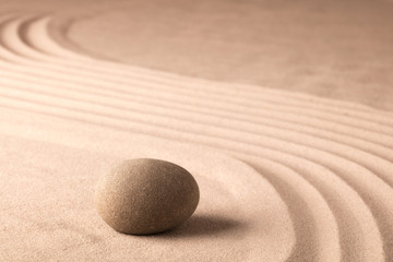Fototapeta na wymiar Stone in zen meditation garden. Texure sand background.