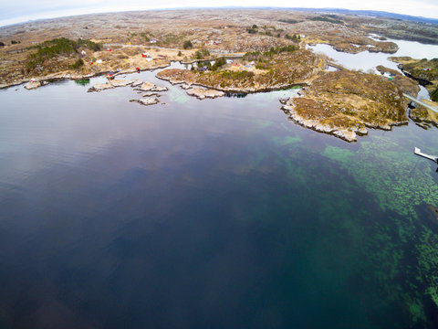 Norwegian fjord in early spring, low fishing buildings