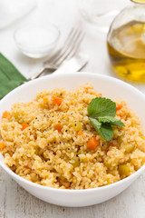 couscous with vegetables in white bowl