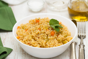 couscous with vegetables in white bowl