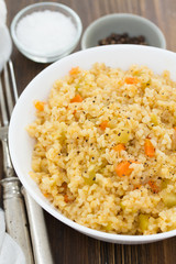 couscous with vegetables in white bowl