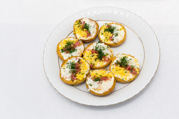 Croutons with sausage, egg and cheese on a plate close up.