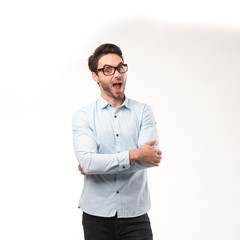 Young happy man showing presentation, pointing on placard over gray background