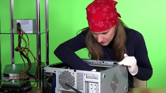 Female computer specialist removing ram memory from desktop computer