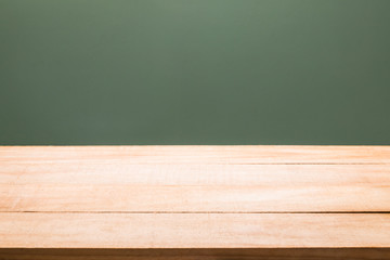 wood table with dark concrete wall background for product display.