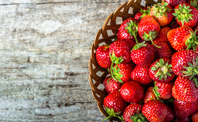 Fresh strawberries in the basket, fruits on farmer market table