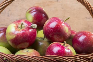 tasty organic apples in a wicker basket