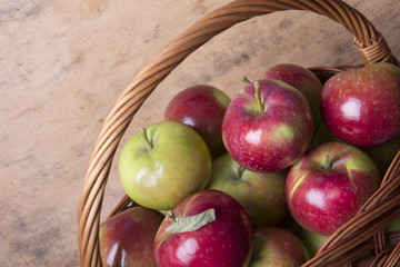 tasty organic apples in a wicker basket