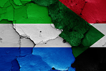 flags of Sierra Leone and Sudan painted on cracked wall
