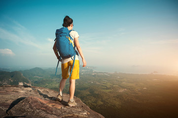 successful woman hiker enjoy the view hiking on mountain peak