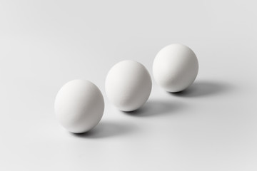 Three white eggs arranged diagonally