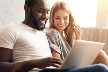 Peaceful international couple relaxing at home