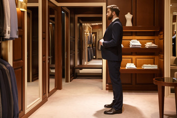 Side view of man tries on a suit