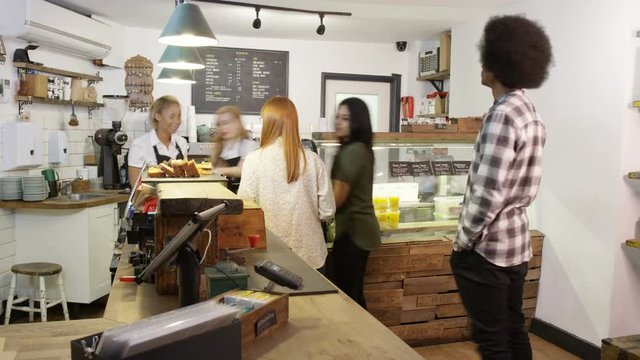  Time lapse of busy staff members serving customers in city coffee shop