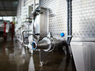 Close up of steel cistern in wine storage 