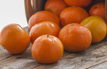 Mandarin Oranges - mandarin oranges on a rustic wooden board.