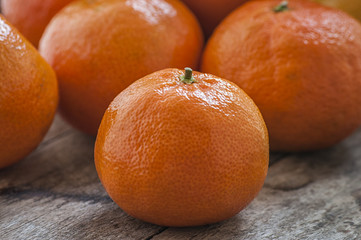 Mandarin Oranges - mandarin oranges on a rustic wooden board.