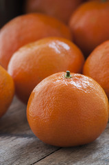 Mandarin Oranges - mandarin oranges on a rustic wooden board.