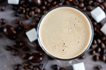 Bottle of black coffee and bottle of coffee with milk lying on background Horizontal photo