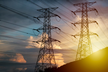 High Voltage Tower on hillside during sunset