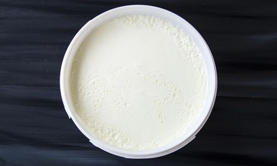 Yogurt in the bucket, yogurt fermented, yoghurt with spoon to take

