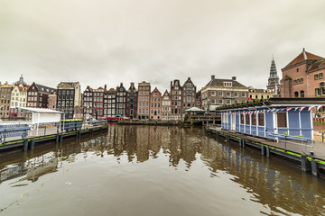 Obraz premium Amsterdam, March 18, 2017: Canals and house view from Amsterdam, where city of bikes, canals and peace